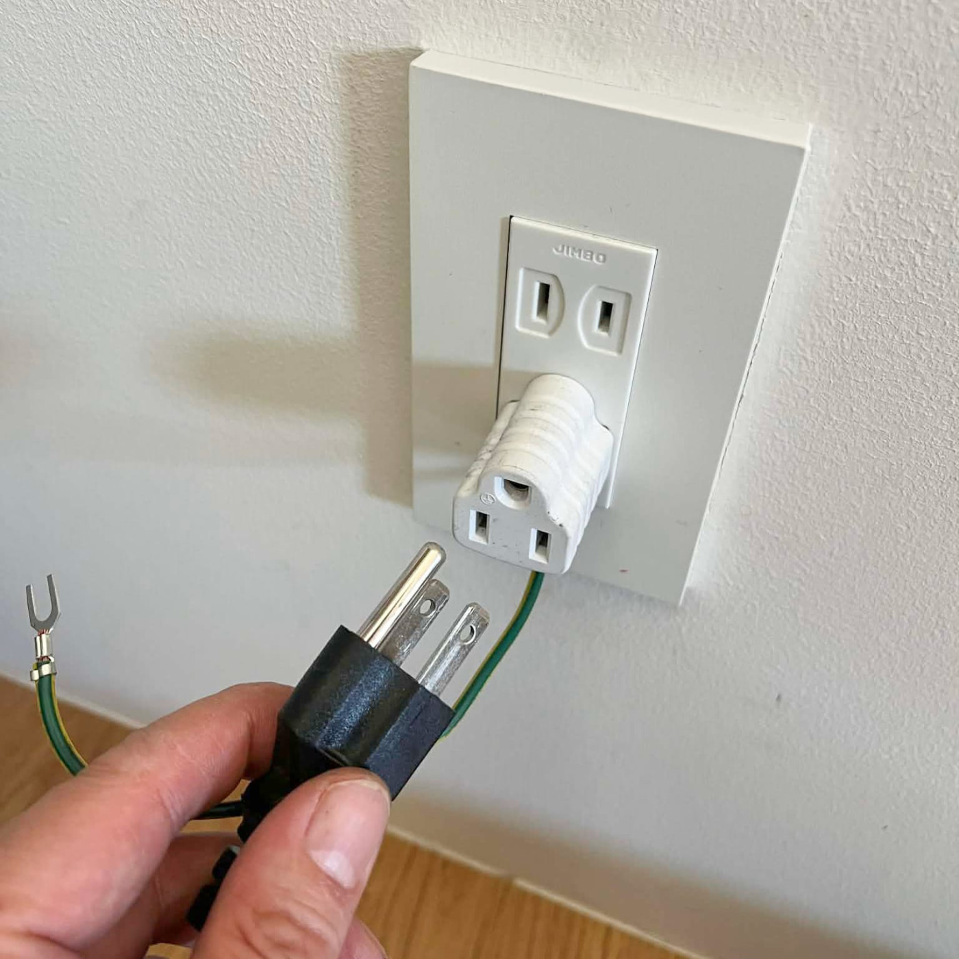 家庭用コンセントは2芯用が多いので、三芯用アダプターを買ってきて挿します。