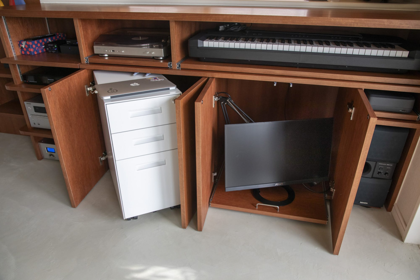 開き戸の収納内部。モニターを置く引き出しの把手には『把手の金物』を使用しています。